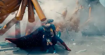 Supermen shielding a child from an explosion with gas bottle flying